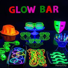 glow party supplies including neon glasses, masks and bracelets on a black table with the words glow bar