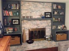 a living room filled with furniture and a fire place in the middle of a wall