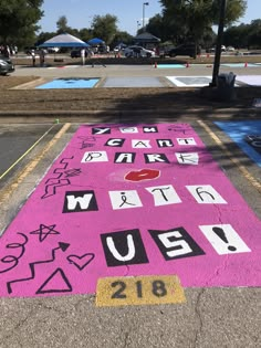 the sidewalk has been decorated with pink and black letters