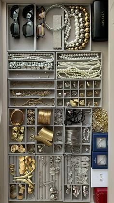 an organized drawer filled with lots of jewelry and bracelets on top of each other