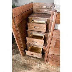 a wooden cabinet with drawers in the corner