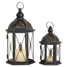 two metal lanterns with candles inside them