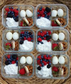 four plastic containers filled with fruit and marshmallows on top of each other