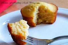 a half eaten muffin on a plate with a fork