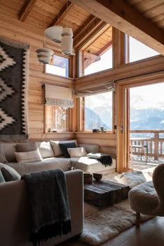 a living room filled with furniture next to a large window covered in wooden planks