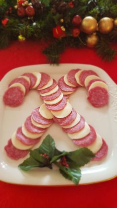 a white plate topped with slices of meat and veggies on top of it