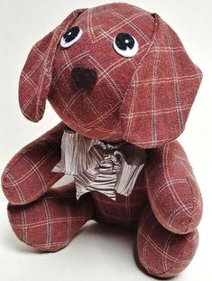 a red dog stuffed animal sitting on top of a white floor