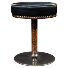 a black stool with gold trim around it