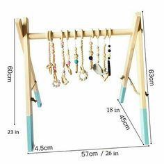 a wooden rack with beads and necklaces hanging from it's sides on a white background