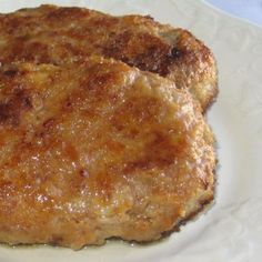 two cooked meat patties on a white plate