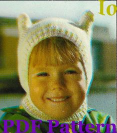 a young child wearing a knitted cat hat and smiling at the camera with text overlay