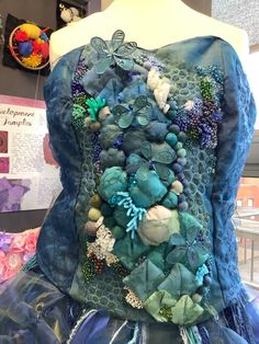 a dress made out of fabric and buttons