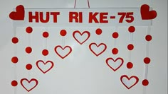 a bulletin board with hearts hanging from it's sides and the words hut rike 75