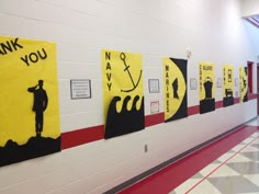 a hallway with posters on the wall that say thank you