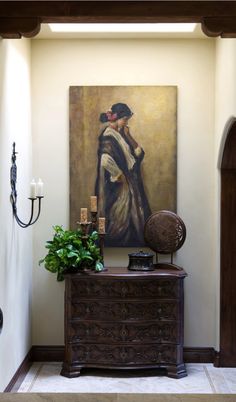 a painting hanging on the wall next to a dresser