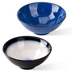 two black and blue bowls with one white bowl in the middle on a white background