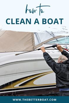 a man holding up a sail boat with the words how to clean a boat on it