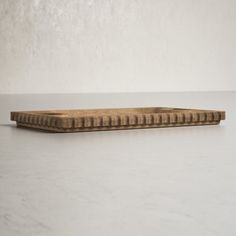 a wooden object sitting on top of a white table