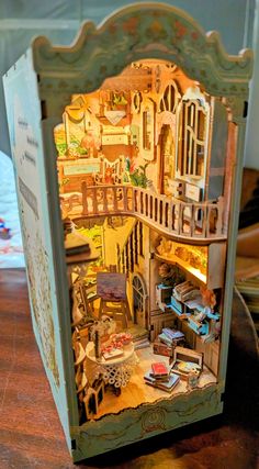 a doll house with furniture and accessories in it's display case on a table