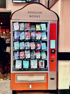 an orange and white vending machine with books on it