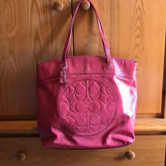 Coach Pink Patent Leather Tote Bag. Not Hot Pink But Not A Dull Pink. Perfect For The Summer! Short-Ish Shoulder Straps, Deep Bag, Two Inside Slip Pockets And One Inside Zipper Pocket. Grey Interior. "C" Pattern On Front Of Bag In A Circle Design And Back Is Plain. Excellent Condition, Barely Used. Bag Color Looks Different Depending On Lighting, But 3rd Picture To Show Keychain Depicts The Actual Color Best. Coach Tote Bag, Grey Interior, Coach Tote Bags, Coach Tote, Gray Interior, A Circle, Circle Design, Leather Tote Bag, Womens Tote Bags