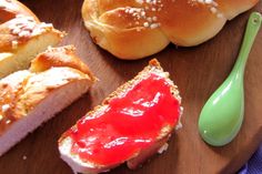 breads and jelly sit on a cutting board