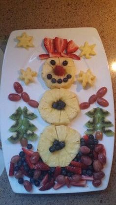 a white plate topped with fruit and veggies