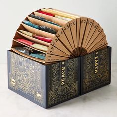 an open box with several different types of paper in it and a fan on top