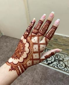 a woman's hand with henna on it