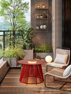 a patio with two chairs and a table on the deck next to potted plants