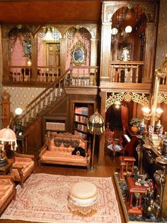 a living room filled with furniture next to a staircase