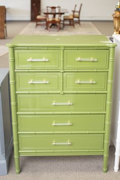 a green dresser sitting in the middle of a room