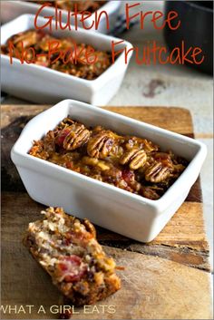 gluten free no bake fruitcake is in a white dish on a wooden cutting board