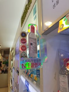 there are many different items on display in the store's front window, including toothpaste and lotion