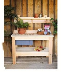 a potted plant sitting on top of a wooden bench