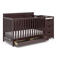 a baby crib with drawers in the bottom half and an open drawer underneath it