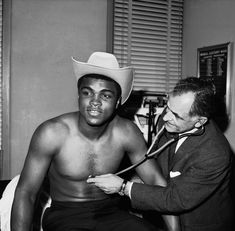 a black and white photo of a shirtless man with a stethoscope