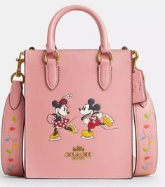 **COACH X DISNEY ... NORTH/SOUTH TOTE** **FEATURING:  MINNIE & MICKEY MOUSE MOTIF** **FABULOUS BLUSH PINK COLOR** **YEAR-ROUND USE** **ALWAYS THE LOWEST PRICE ON THE INTERNET** Details: *Brand new with original price tags attached... *Retail price:  $398.00 + tax... *Style #CN023... *Color:  Light Blush, Multi... *Material:  refined calf leather... *Interior:  2 credit card slots... *Magnetic snap closure... *Fabric lining... *Top Handles with:  2 1/4" drop... *Removable crossbody strap with 23 1/4" drop for shoulder or crossbody wear...  2 in 1 ... Tote & CrossBody... *Measurements: 5.5"L x 6 3/4"H x 2"W... *Leather:  Coach x Disney hangtag... *Interior:  leather authenticity patch... *Free shipping... *Arrives at your home wrapped in Coach paper; gift boxes are available  ... message us. Funky Purses, Disney Backpack, Coach Disney, Disney Purse, Disney Bags, Summer Boots, Disney Handbags, Ice Skate, Girly Bags