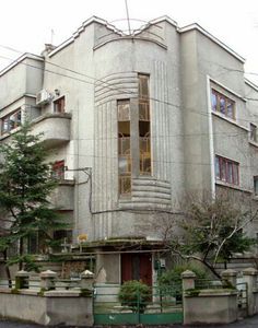 an old building with many windows on the corner