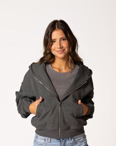 The Favorite Cropped Zip-Up is THE piece you need — immediately. The fabric and fit of this piece are what makes it a true winner. The outward-facing side is buttery soft to the touch, while the inside is soft, cozy fleece that only gets better with wear and time. Grab it on the go whenever you need a layering piece that can keep up with you all day long. FIT & FABRIC: Made from soft and cozy mid-weight cotton/span jersey fleece. Relaxed, cropped fit that hits at the waist. Front zip for easy la Crop Zip Up Hoodie Outfit, Coffee Shop Barista, Crop Zip Up Hoodie, Skincare Accessories, Dark Grey Hoodie, Cropped Zip Up Hoodie, Cropped Zip Up, Outfits Jewelry, Hawaii Trip