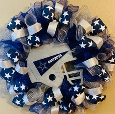 a wreath with a football helmet and stars on it that says cowboys in the center