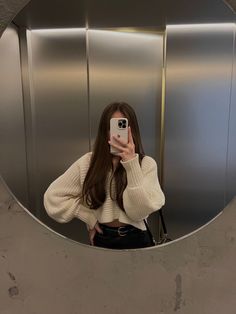 a woman taking a selfie in an elevator