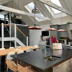 an open kitchen and dining room with skylights