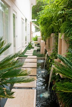 an outdoor water feature in the middle of a garden