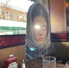 a woman's head is lit up in the middle of a kitchen counter top