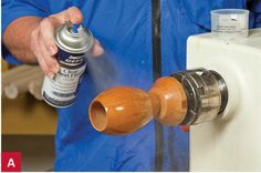 a man is holding a spray can next to a heater