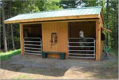 two horses are standing in their stalls