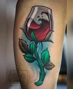 a rose and wine glass tattoo on the leg