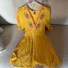 Dukes Of Dallas Brand, Never Worn, New With Tags, Size S, Flowy Fit And Waist Can Be Tightened, Embroidered Floral Designs, Great For Summer, Spring, Vacations Mustard V-neck Flowy Dress, Mustard Flowy V-neck Dress, Embroidered V-neck Summer Mini Dress, Summer V-neck Embroidered Mini Dress, Forever 21 Bohemian Dress For Vacation, Forever 21 Flowy Bohemian Dress, Forever 21 Bohemian Flowy Dress, Yellow Short Sleeve Mini Dress For Vacation, Mustard Mini Dress For Spring