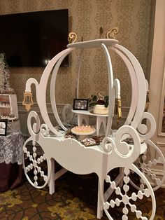 an elaborately decorated carriage is displayed in front of a christmas tree and other decorations